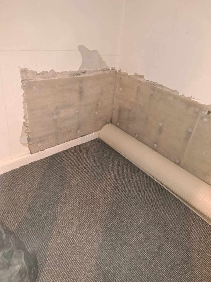 Cavity-drain membrane being installed on a Newcastle basement wall by Newcastle Barrier Damp Proofing