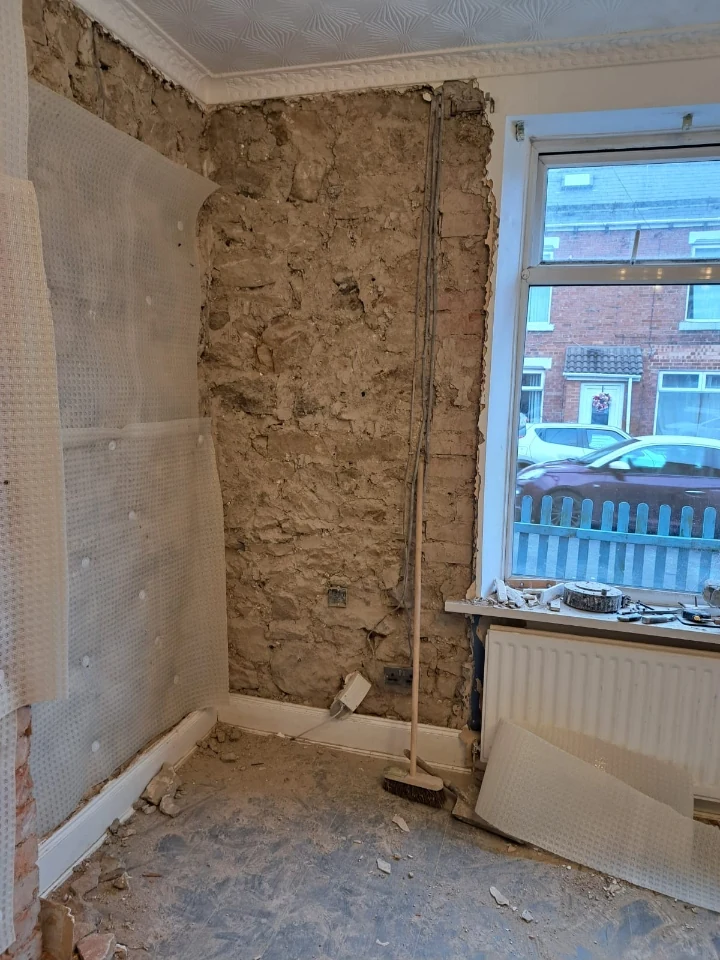 Wall strip-out exposing penetrating damp on a Newcastle property