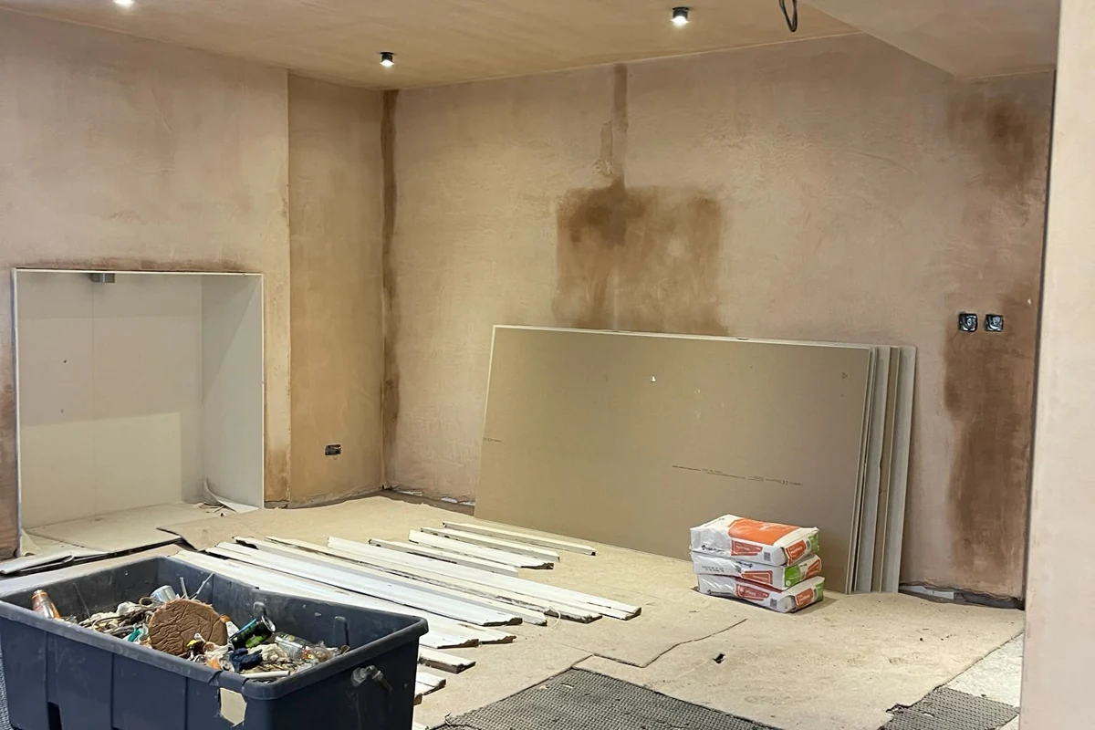 Replastering in progress after cavity-drain membrane installation in a Newcastle basement
